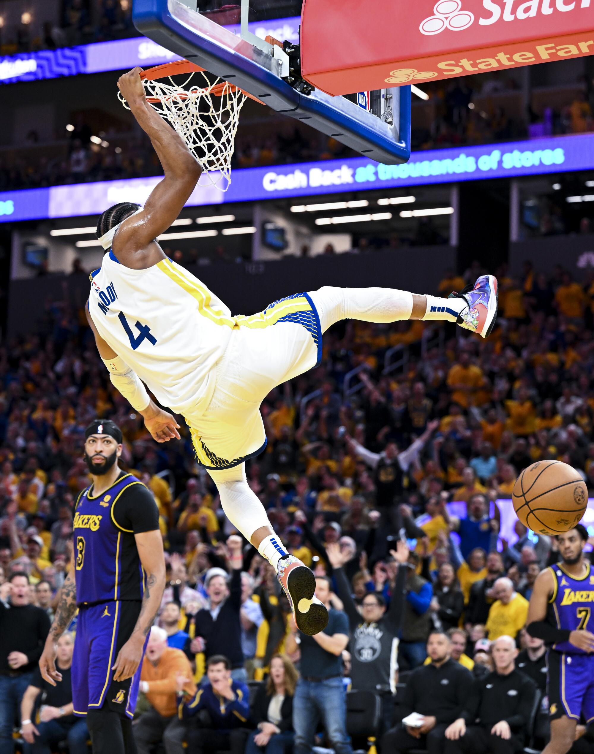 Lakers forward Anthony Davis watches after Warriors guard Moses Moody hangs on the rim.