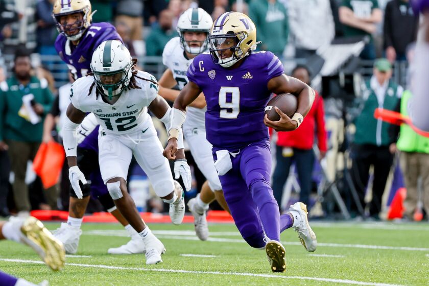 Washington quarterback Michael Penix Jr. (9) takes off on a rush against Michigan State during the second quarter of an NCAA college football game Saturday, Sept. 17, 2022, in Seattle. (Jennifer Buchanan/The Seattle Times via AP)