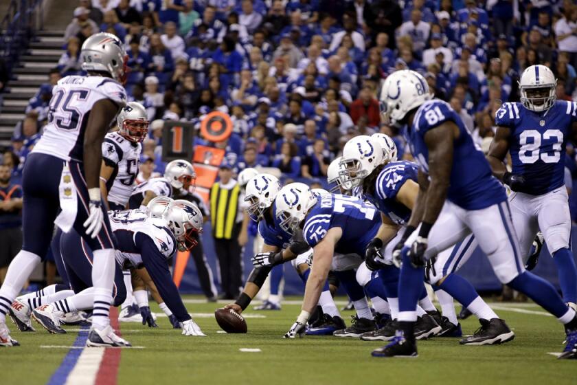 Members of the New England Patriots and Indianapolis Colts on the line of scrimmage in the second half of a game on Sunday.