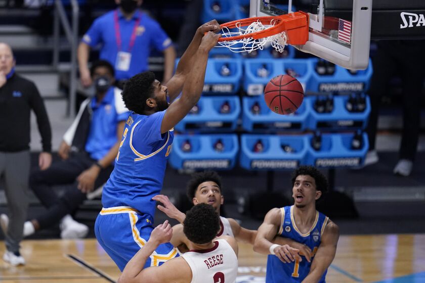 UCLA forward Cody Riley (2) dunks on Alabama forward Alex Reese (3) in the second half of a Sweet 16 game.