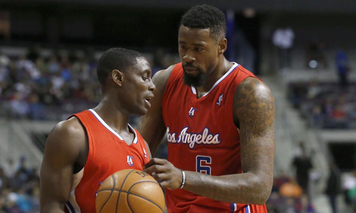 Clippers point guard Darren Collison, left, and center DeAndre Jordan talk during Monday's win over the Detroit Pistons.
