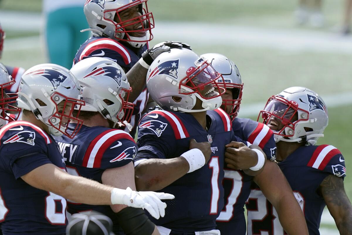 New England Patriots quarterback Cam Newton celebrates after scoring a touchdown.