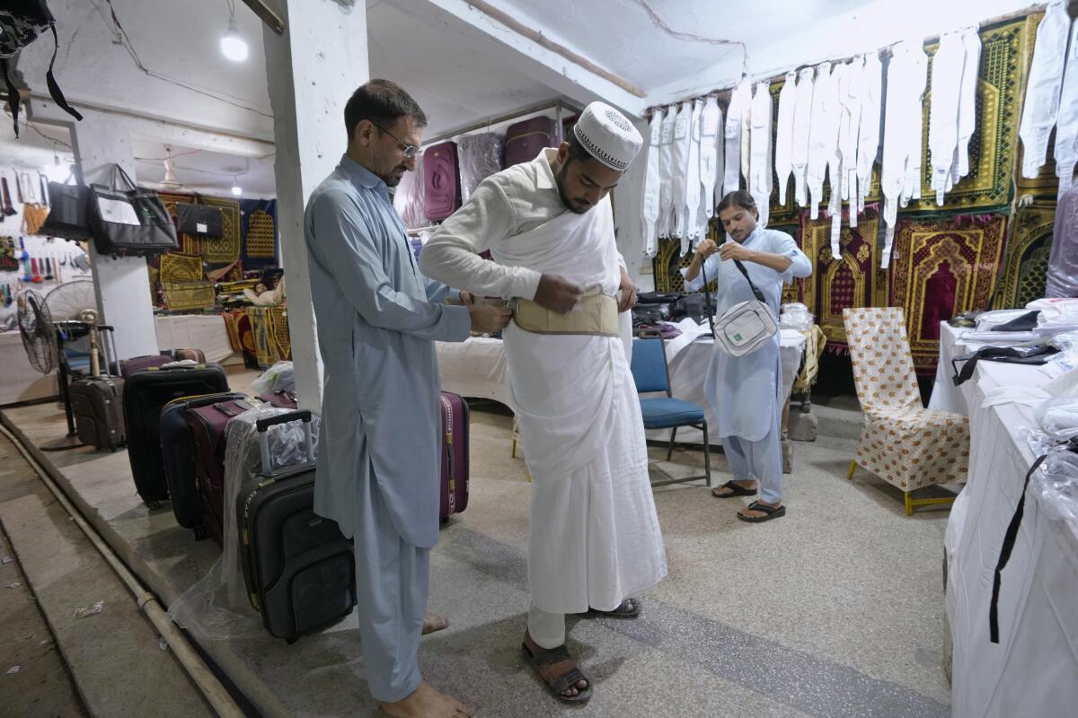 A pilgrim buys a money belt at a Hajj training center in Karachi, Pakistan
