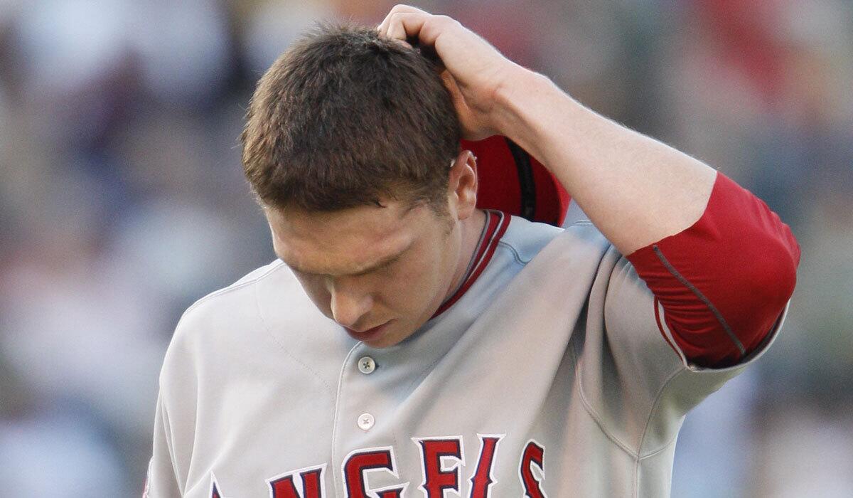 Los Angeles Angels starting pitcher Scott Kazmir walks back to the dugout after giving up eight runs in the third inning of their baseball game against the Oakland Athletics in Oakland, Calif., Saturday, July 10, 2010. (AP Photo/Eric Risberg)