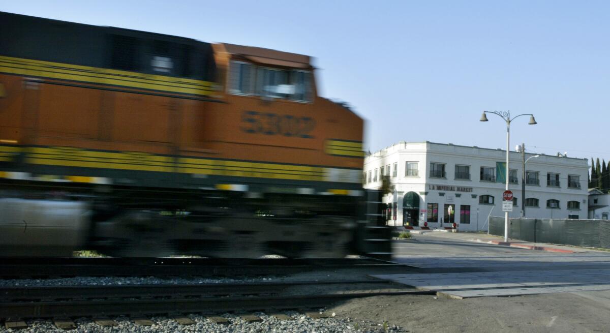 A train chugs through oldtown Placentia. A judge told a former transportation director that he risks going to jail unless he pays back his salary.