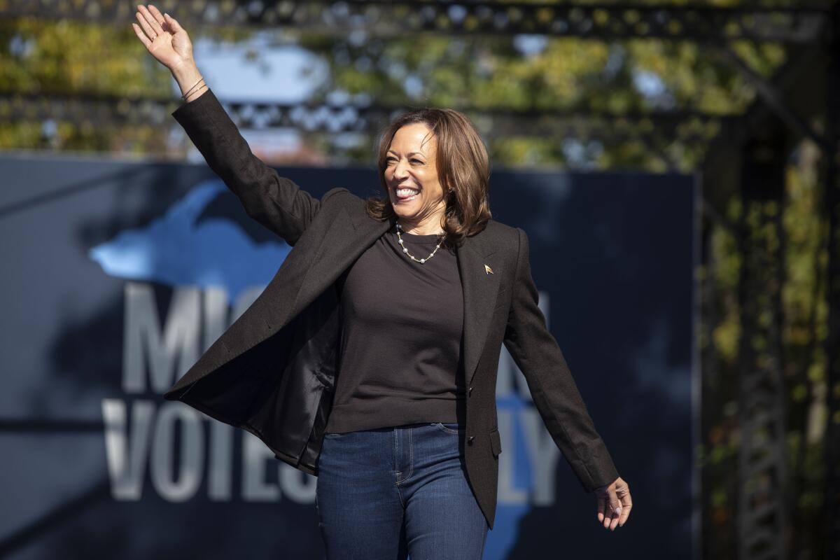 Kamala Harris walking on an outdoor stage