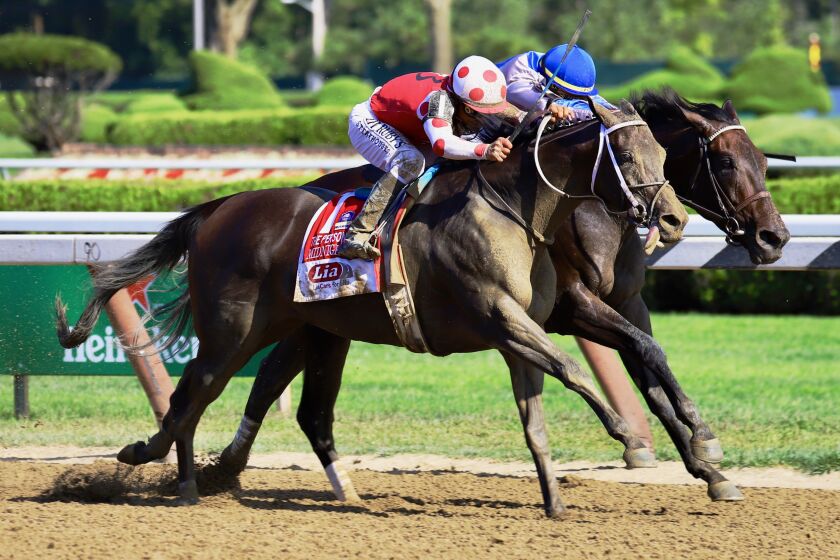 Midnight Bisou (outside) edges past Elate to win the Personal Ensign Stakes on Saturday at Saratoga.