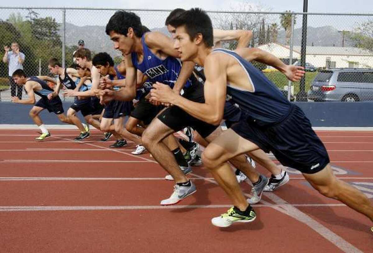 Crescenta Valley and Burbank high runners lean forward at the start of the 800-meter race in a dual Pacific League track meet at Burbank High.