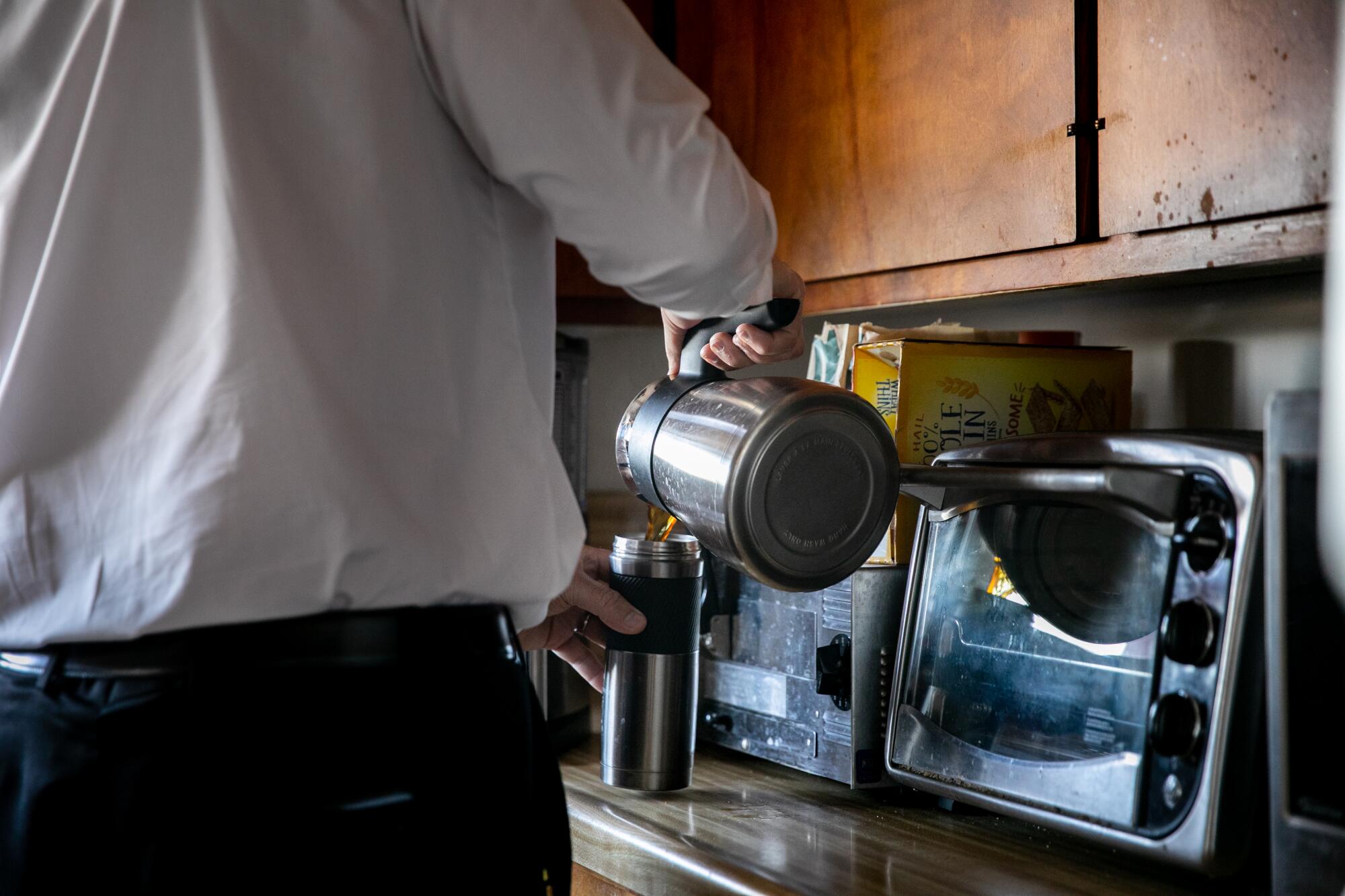 Robert Zakar pours himself a cup of coffee as he starts another long day of work on Wednesday.