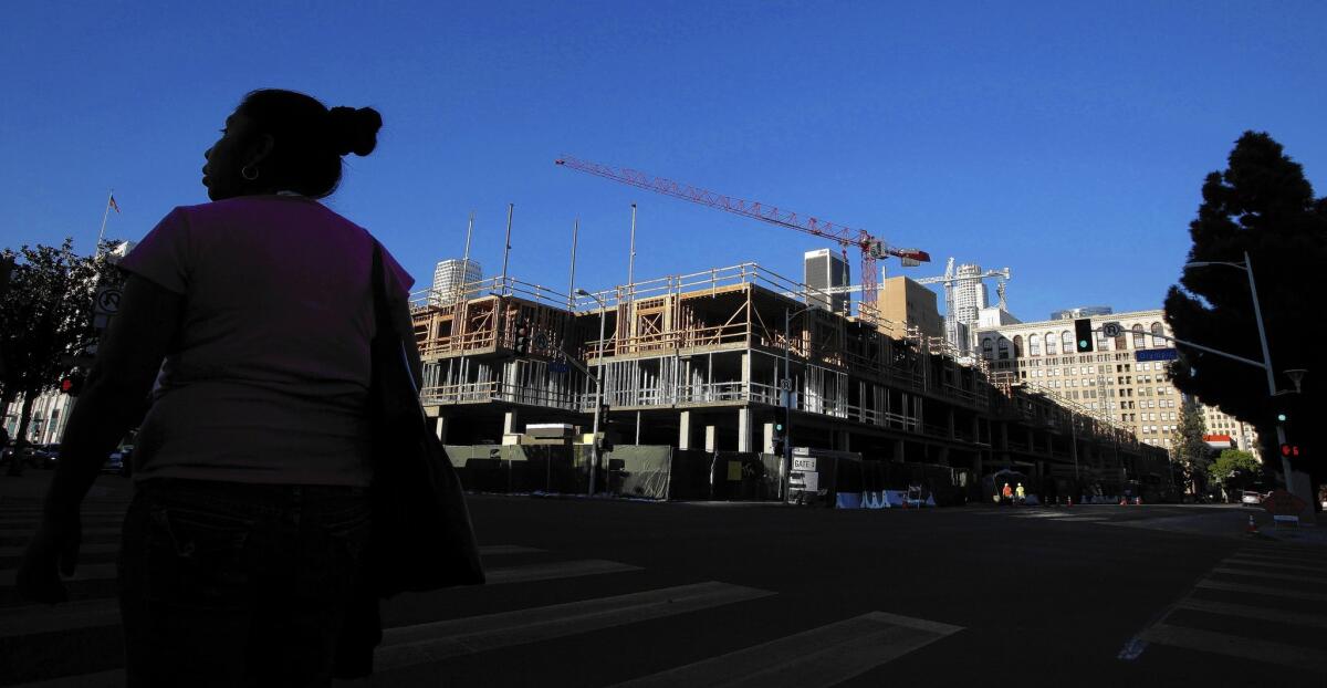 Building permits were issued for nearly 17,000 units in apartment and condo buildings in Los Angeles and Orange counties last year, the most since 2006, according to the Census Bureau. Above, an apartment complex under construction in downtown L.A. in January.