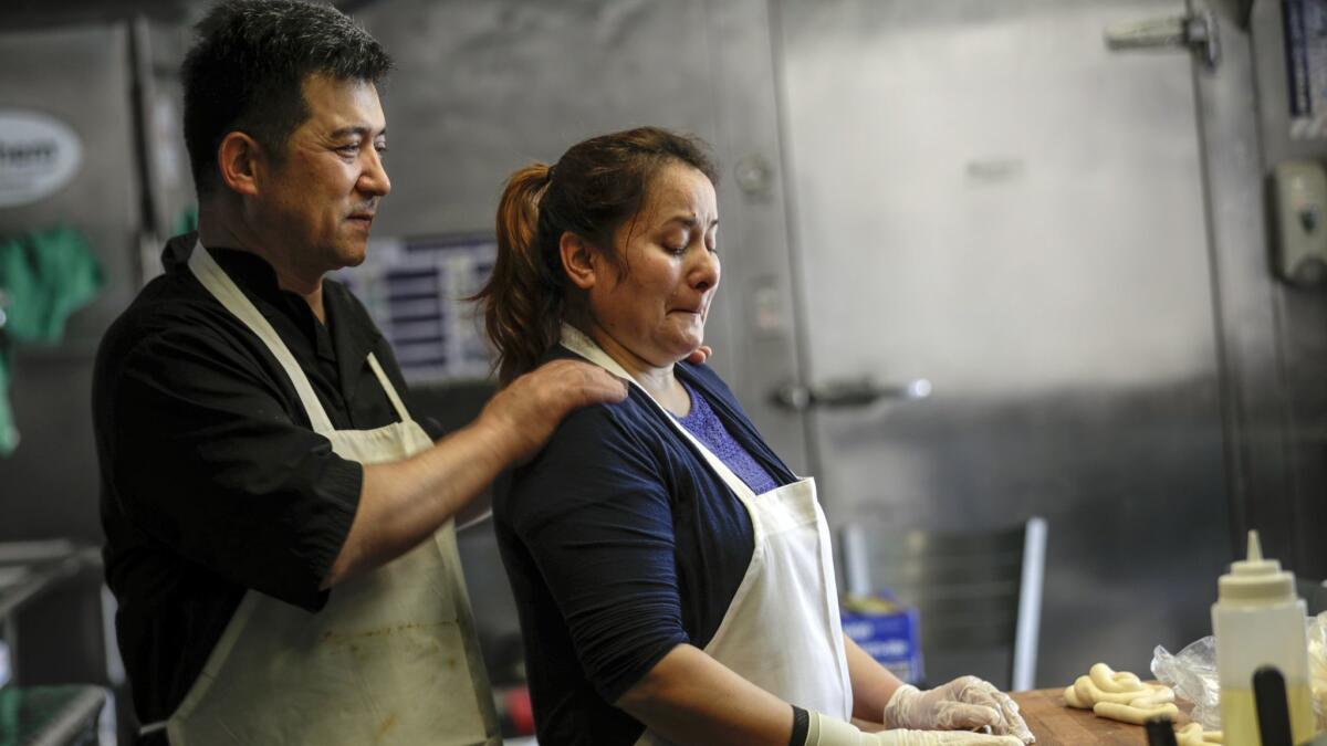 Two people in a restaurant kitchen