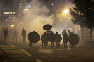 FILE - Tear gas fills the air during protests in Portland, Ore., on Sept. 18, 2020. Questions posed by lawmakers, medical workers and experts about the safety of tear gas remain unanswered, even after more than a dozen U.S. senators asked a congressional watchdog to look into the issue. (AP Photo/Paula Bronstein, File)
