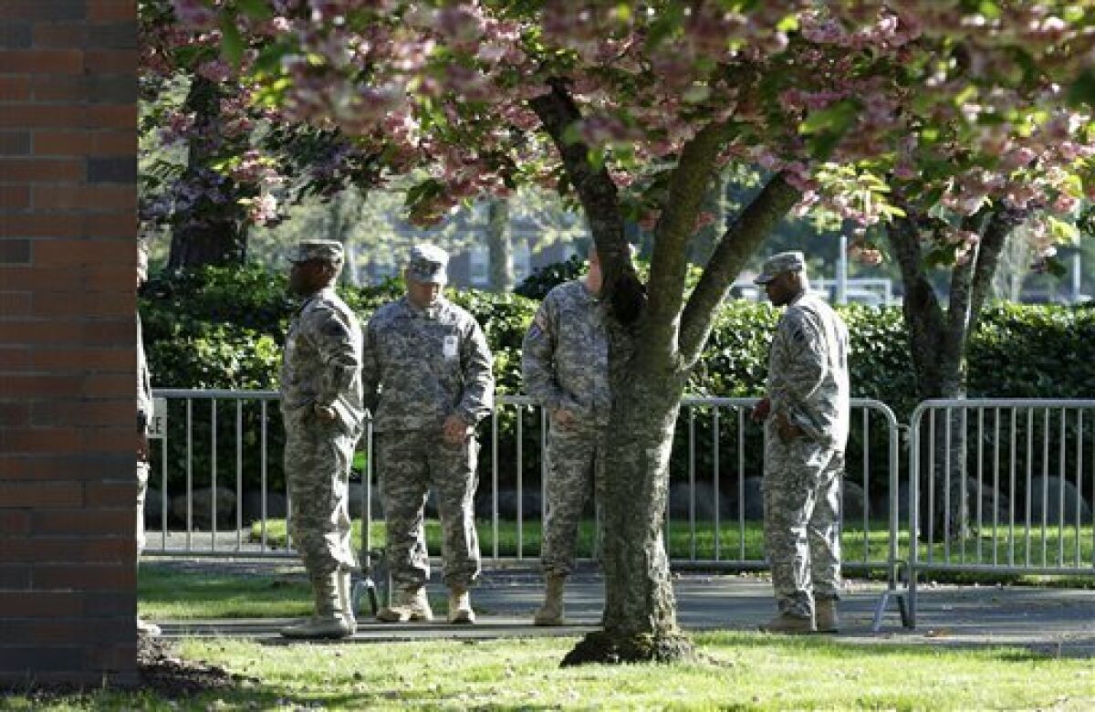 Soldiers assisting with communications and security tasks stand outside the building at Joint Base Lewis-McChord, Wash., during the court-martial for Army Sgt. John Russell.
