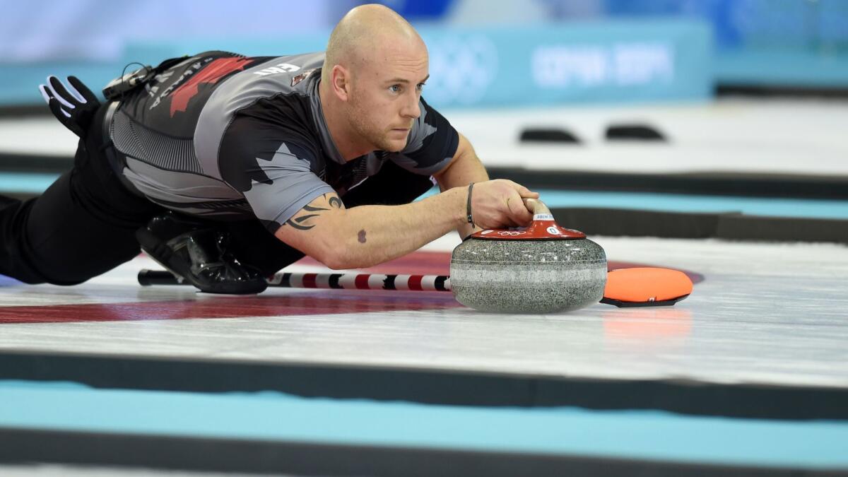 Canada's Ryan Fry throws the stone during the men's curling gold medal game against Britain during the Sochi Winter Olympics on Feb. 21, 2014.