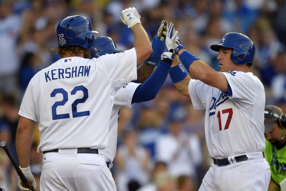 Dodgers' A.J. Ellis, right, celebrates his two-run home run with teammates Carl Crawford and Clayton Kershaw during Game 1 of a National League division series against the St. Louis Cardinals on Oct. 3.