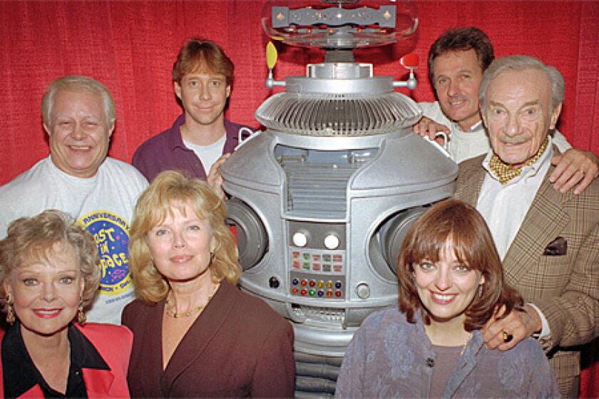 The crew from the original cast of the television series "Lost in Space" pose with the show's robot in in a 1995 file photo. From left in the back row are: Bob May, Bill Mumy, Mark Goddard, Jonathan Harris; in the front row from left: June Lockhart, Marta Kristen, Angela Cartwright.
