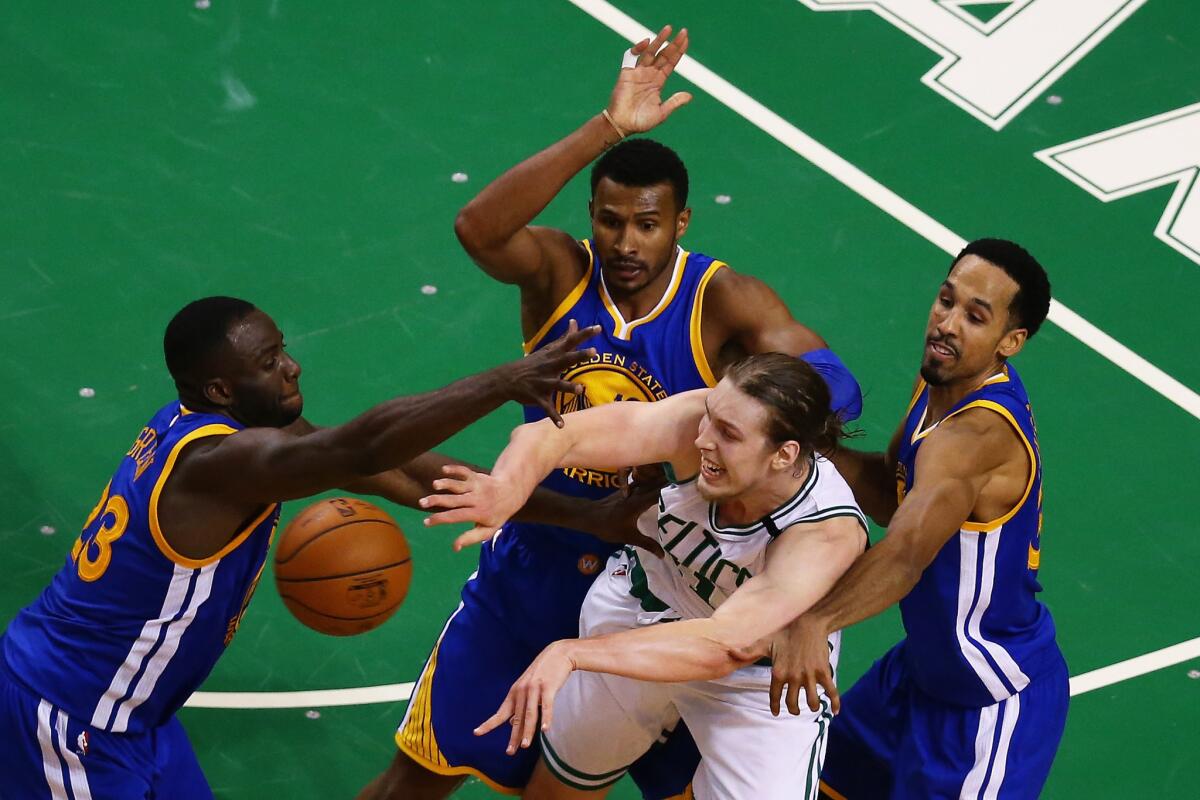 Warriors defenders Draymond Green (23), Leandro Barbosa, middle, and Shaun Livingston, right, swarm Celtics center Kelly Olynyk during double overtime.