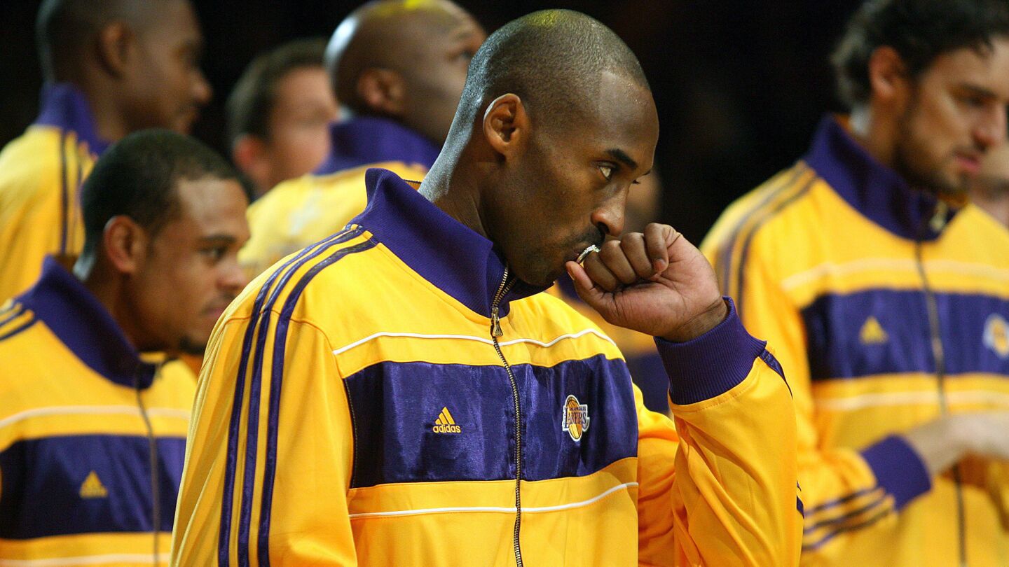 Kobe Bryant kisses his championship ring during a ceremony honoring the Lakers' 2010 NBA title before the team's season opener on Oct. 26, 2010.