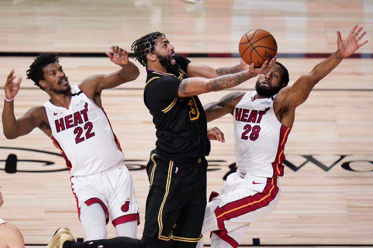Lakers forward Anthony Davis shoots between Miami's Jimmy Butler and Andre Iguodala (28) during Game 5 of the NBA Finals.
