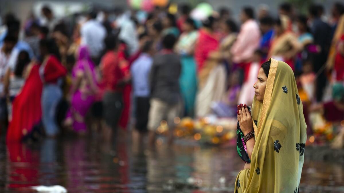 A Hindu devotee prays to the Sun god while standing in knee-deep waters this month in River Yamuna during the Chhath festival in New Delhi, India. You can fly to the north-central Indian city for $461 round trip on China Southern.