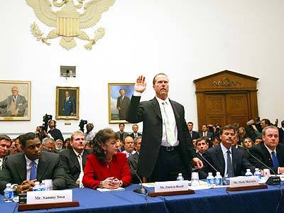 Former Major League Baseball player Mark McGwire is sworn in before testifying at a hearing on Capitol Hill on the use of steroids in baseball. Also appearing, from left, the Baltimore Orioles' Sammy Sosa, his interpreter Patricia Rosell, the Orioles' Rafael Palmiero and the Boston Red Sox's Curt Schilling.