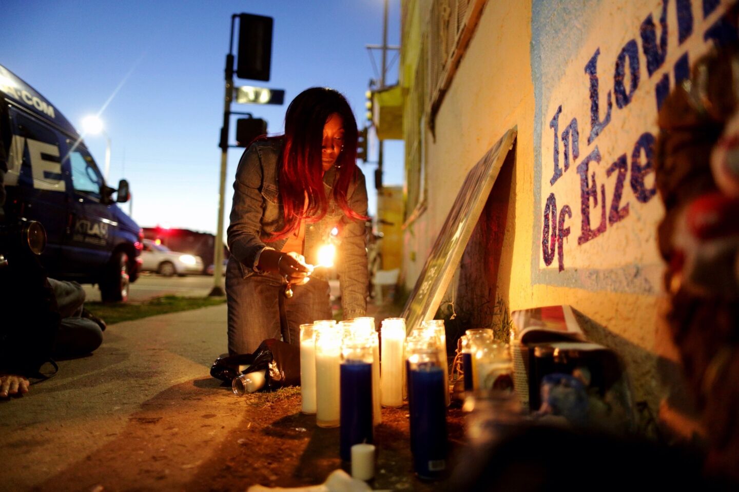 Tritobia Ford, mother of Ezell Ford, lights candles at her slain son's memorial at 65th Street and Broadway after the LAPD released Ezell Ford's autopsy results.