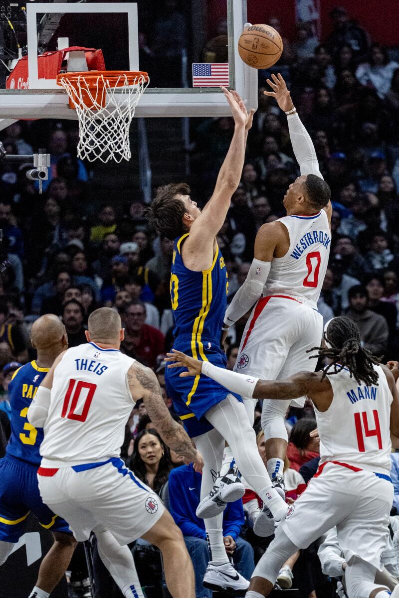 Clippers guard Russell Westbrook scores over Warriors forward Dario Saric in the second half.