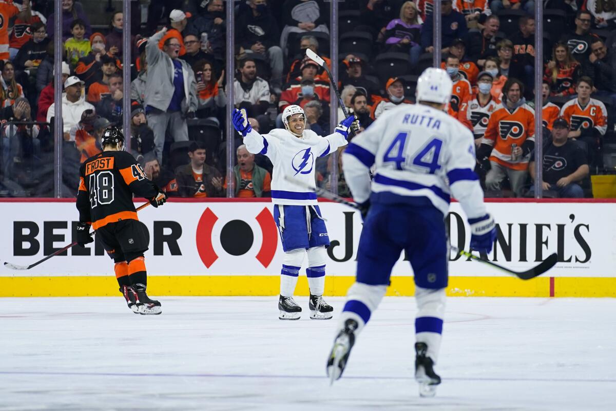 Tampa Bay Lightning's Mathieu Joseph, center, reacts after scoring a goal during the second period of an NHL hockey game against the Philadelphia Flyers, Sunday, Dec. 5, 2021, in Philadelphia. (AP Photo/Matt Slocum)