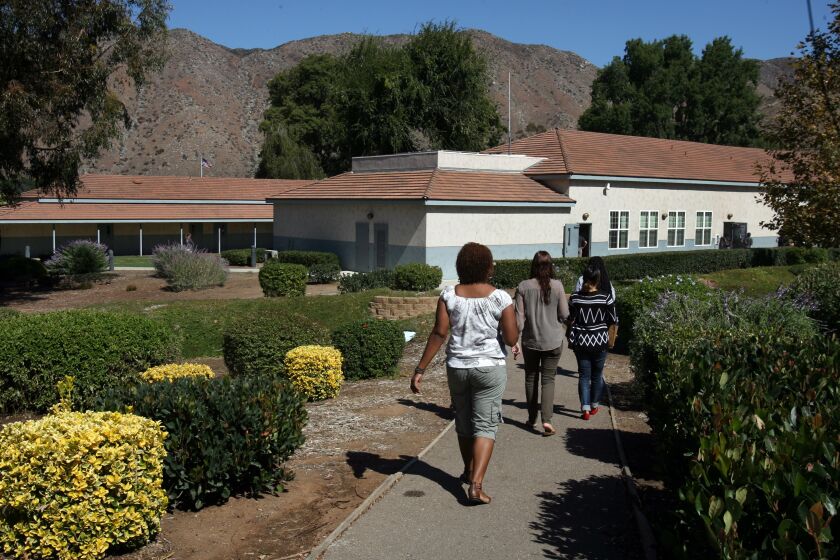 Students and teachers walk the San Pasqual Academy campus during a class change.