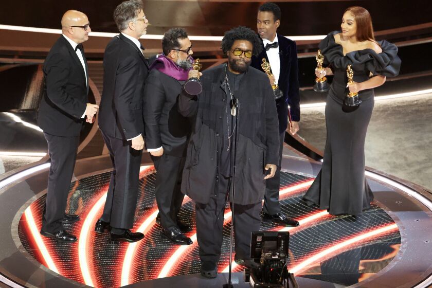 HOLLYWOOD, CA - March 27, 2022. Ahmir "Questlove" Thompson in the center accepts the award for for Best documentary feature nominees for "Summer of Soul" onstage during the show at the 94th Academy Awards at the Dolby Theatre at Ovation Hollywood on Sunday, March 27, 2022. (Myung Chun / Los Angeles Times)