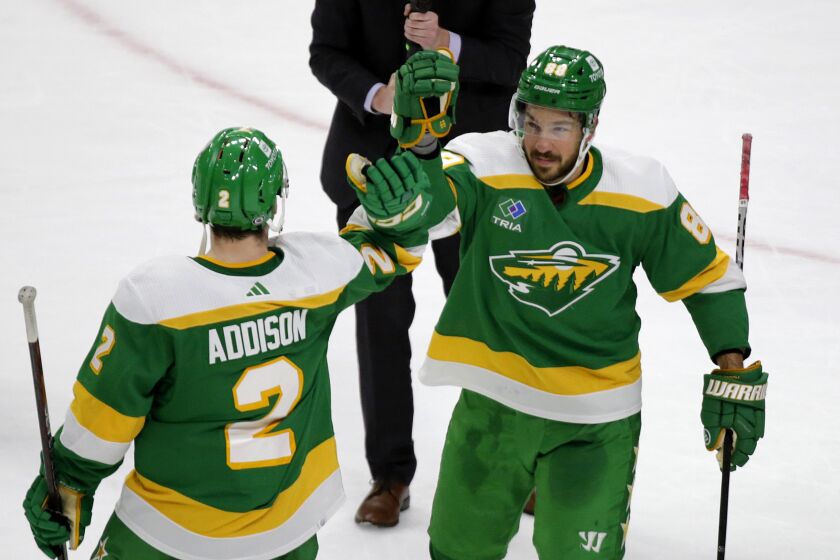 Minnesota Wild center Frederick Gaudreau (89) celebrates with teammate Calen Addison (2) after scoring the winning goal in a shootout of an NHL hockey game against the Buffalo Sabres, Saturday, Jan. 28, 2023, in St. Paul, Minn. (AP Photo/Andy Clayton-King)