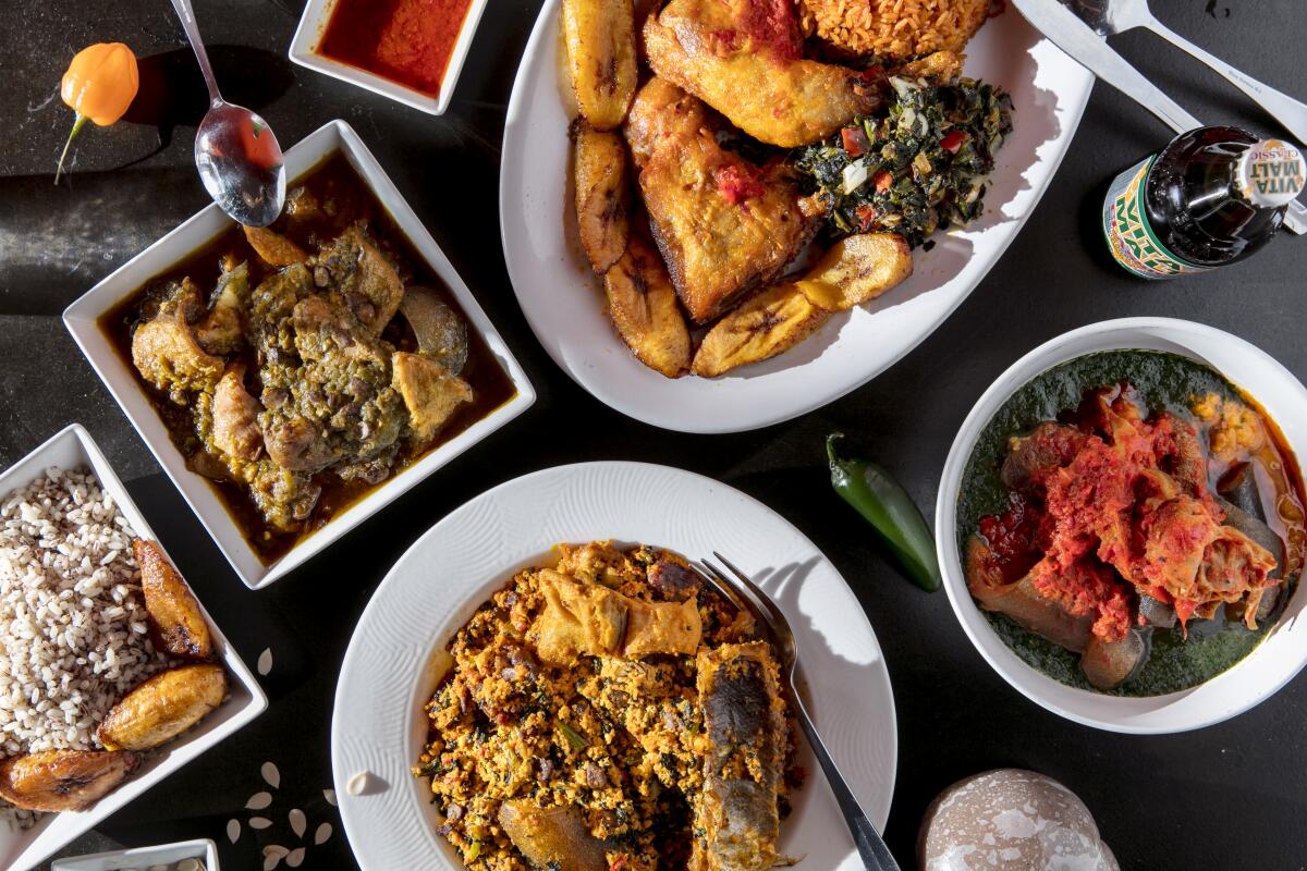 A spread of dishes at Aduke African Cuisine includes, clockwise from left, ofada rice with ayamase stew; jollof rice combo with fried chicken, plantains and spinach; ewedu, a jute-leaf soup served with assorted meat; and egusi stew.