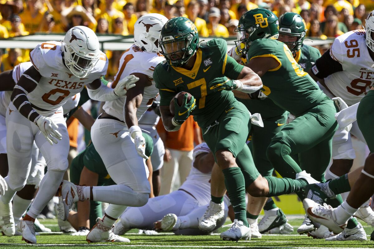 Baylor running back Abram Smith (7) runs with the ball during the second half of an NCAA college football game against Texas, Saturday, Oct. 30, 2021, in Waco, Texas. (AP Photo/Sam Hodde)