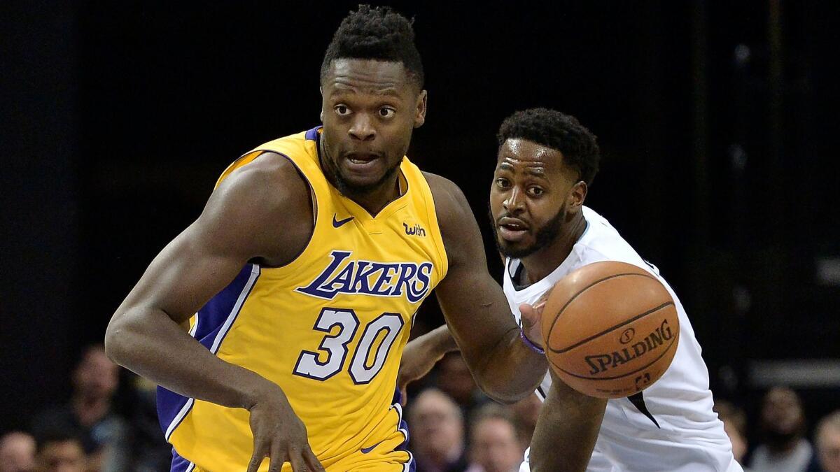 Lakers forward Julius Randle controls the ball against Memphis forward JaMychal Green on Jan. 15.