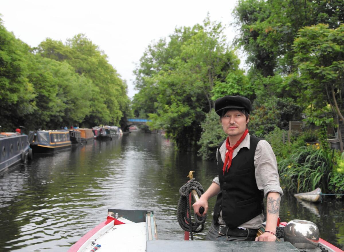 Toni Haimi steers his narrowboat through one of London's canals.