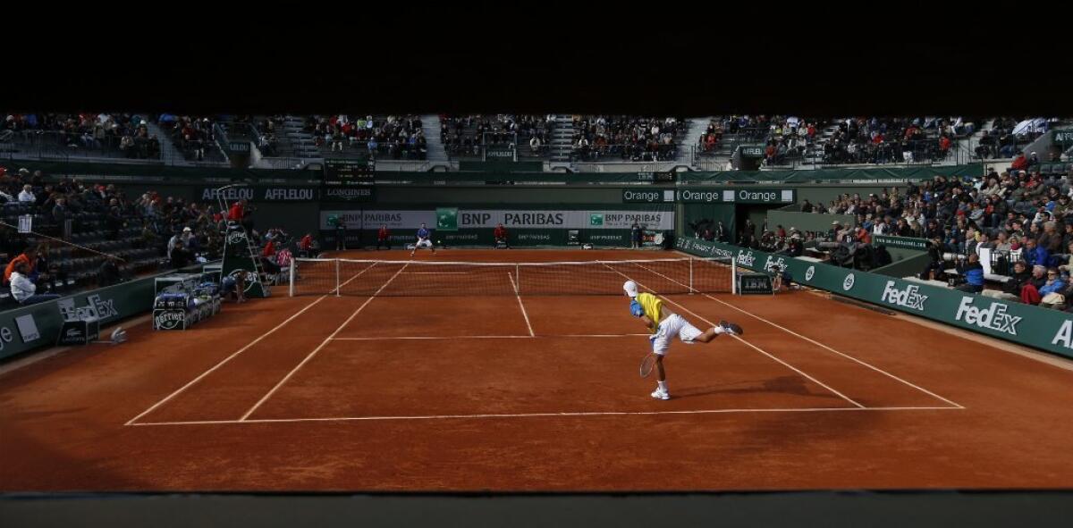 Comcast wins an appeals court victory in its marathon legal dispute against the Tennis Channel. Above, Netherlands' Thiemo de Bakker serves against Switzerland's Stanislas Wawrinka at the French Open at Roland Garros stadium in Paris.