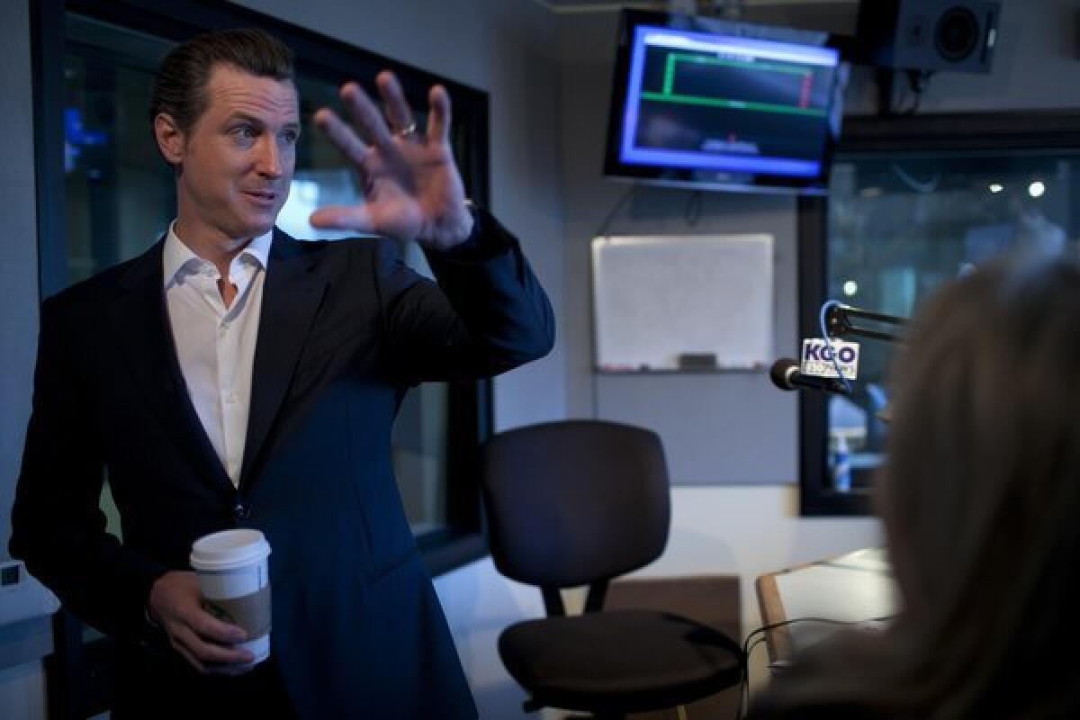 Lt. Gov. Gavin Newsom leaves after appearing with Jennifer Jones Lee and Jon Bristow at KGO Morning News radio in San Francisco.