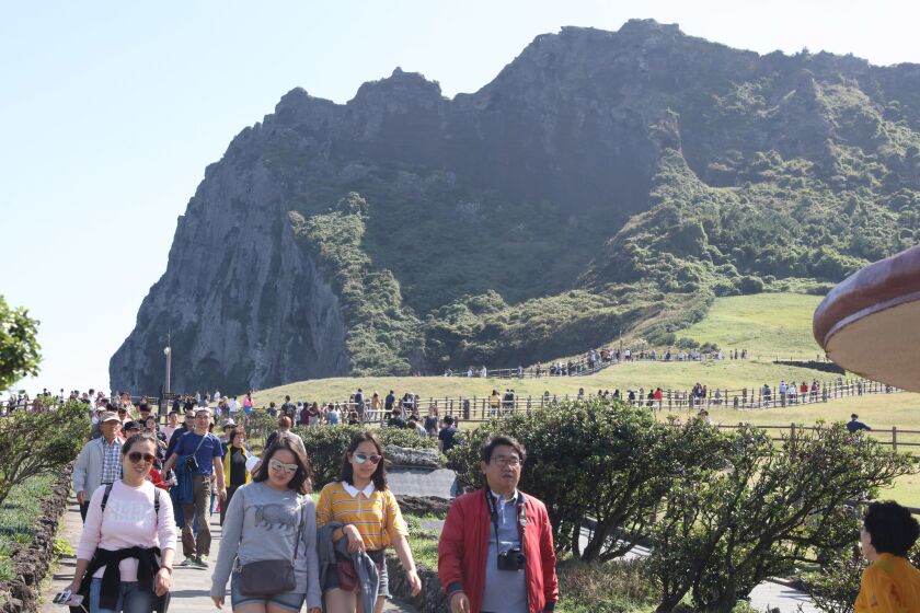 SOUTH KOREA OUT Mandatory Credit: Photo by YONHAP/EPA-EFE/REX/Shutterstock (9122752b) Tourists flock to Seongsan Ilchulbong, or Sunrise Peak, on Jeju Island, South Korea, 07 October 2017. Jeju Island tourism, Korea - 07 Oct 2017