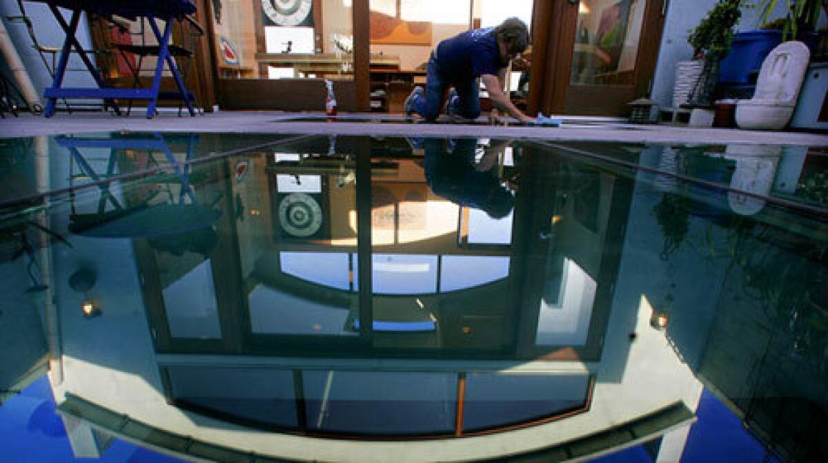 A pool? Nope, just the glass floor at the Venice home of artist Nancy Evans and woodworker Tucker Strasser.