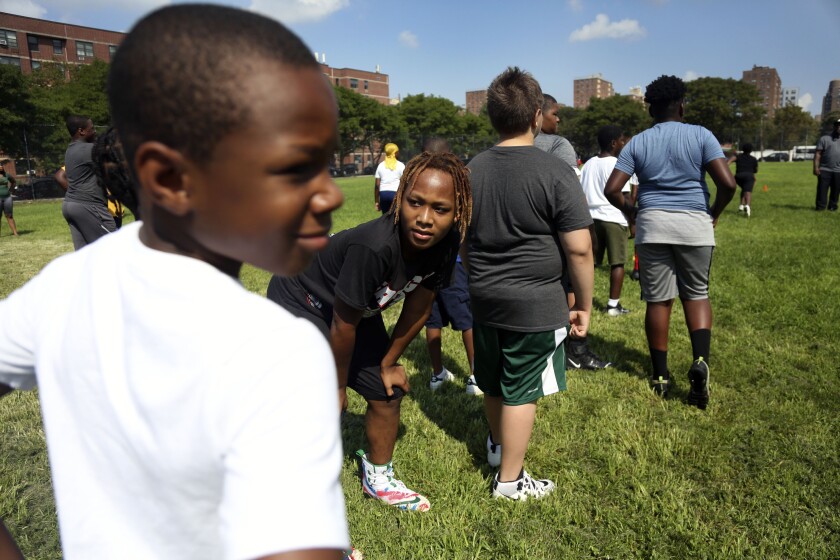 Mason Washington at his teammates at football practice