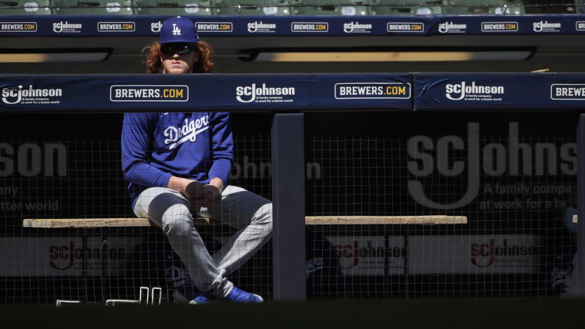 The Dodgers' Dustin May watches a game from the dugout last season