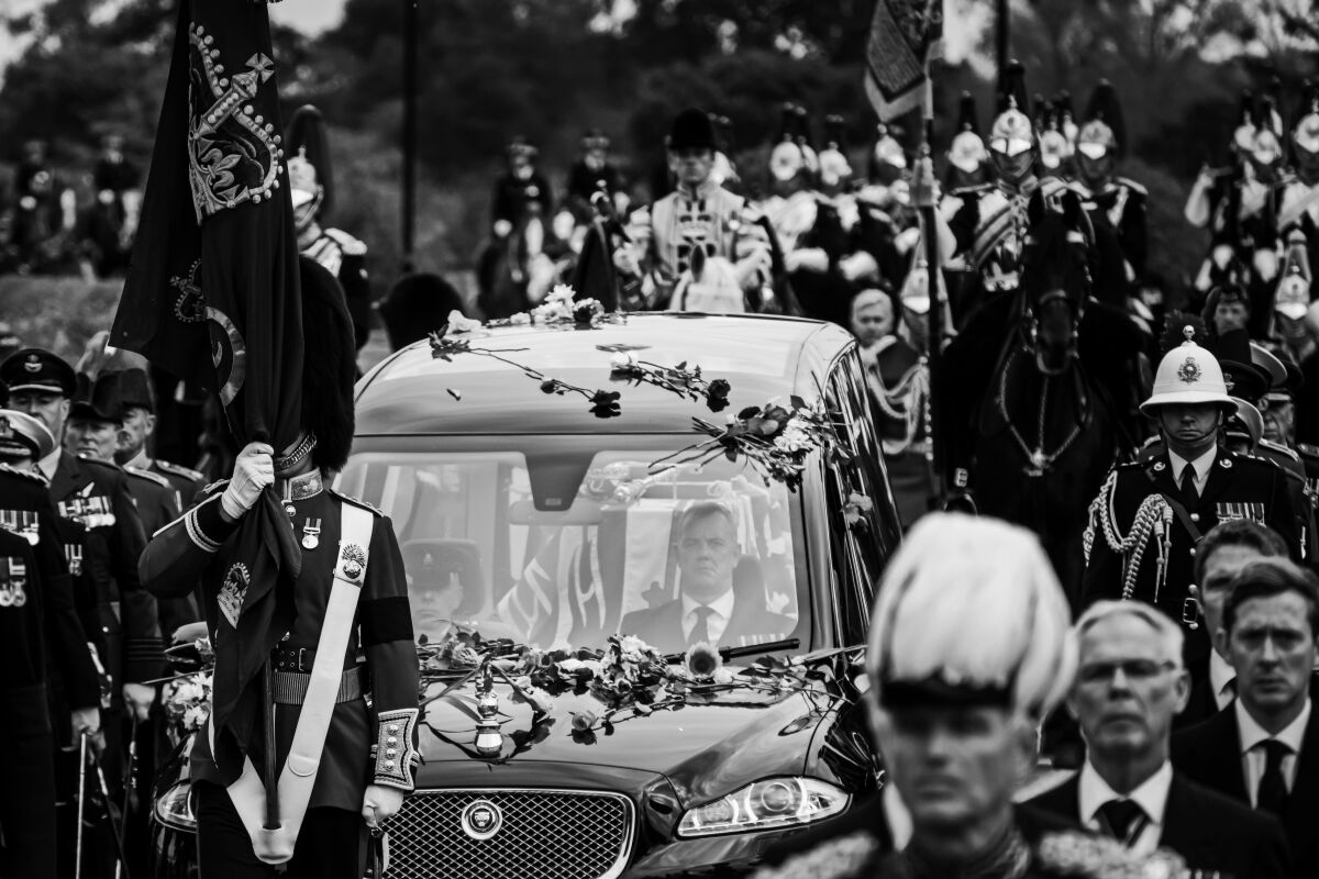  A hearse bearing the coffin of Queen Elizabeth II is covered in flowers as it slowly makes its way towards Windsor Castle 