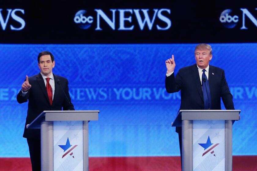 Sen. Marco Rubio of Florida, left, and Donald Trump try to get a word in at St. Anselm College in Manchester, N.H.