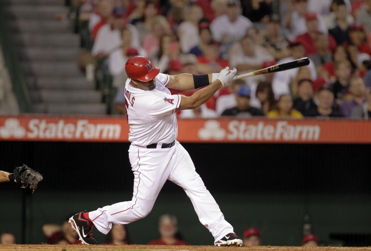 Angels slugger Albert Pujols hits a home run during the third inning of Friday's game against the Oakland Athletics.
