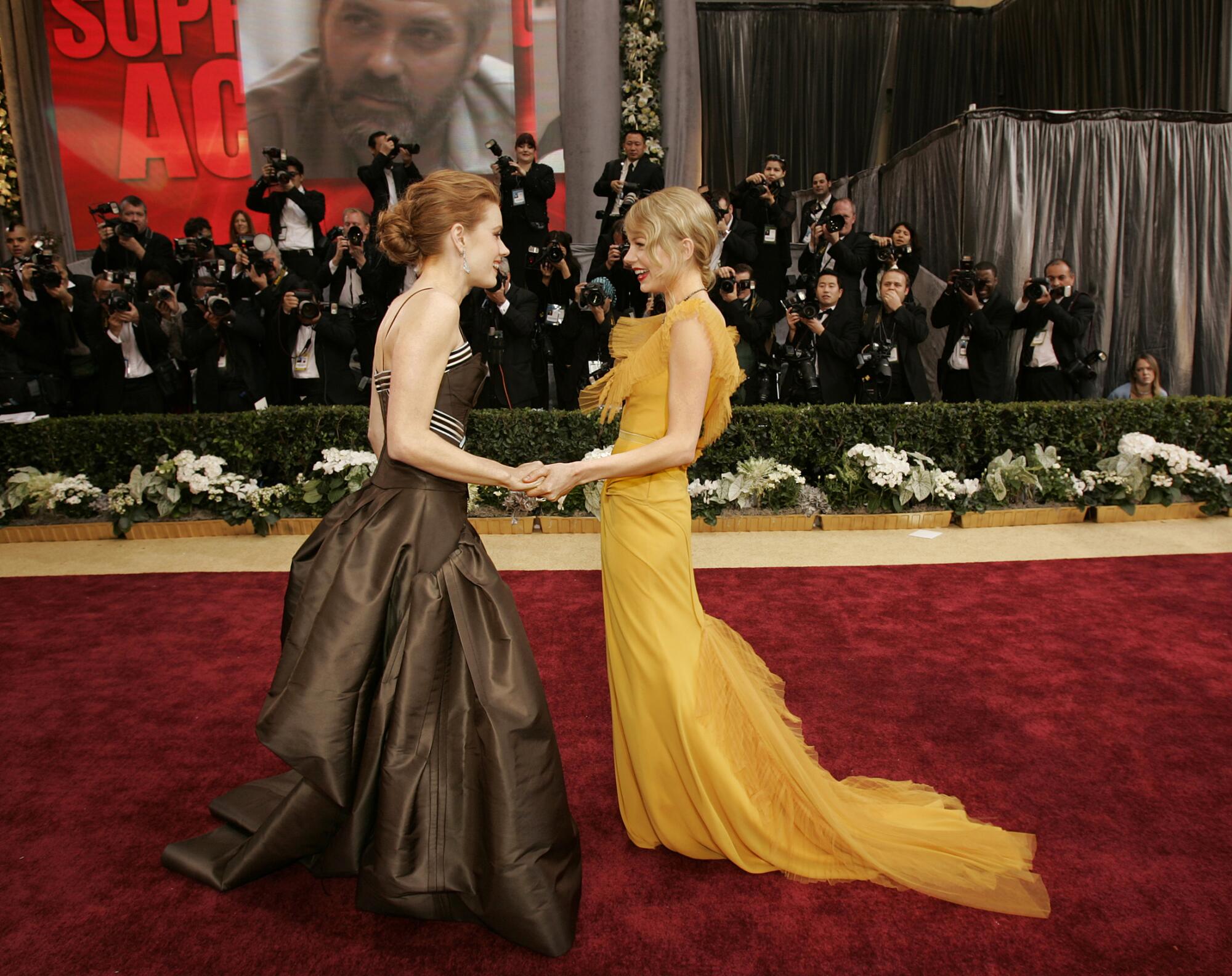 2006: Amy Adams, left, and Michelle Williams meet on the red carpet
