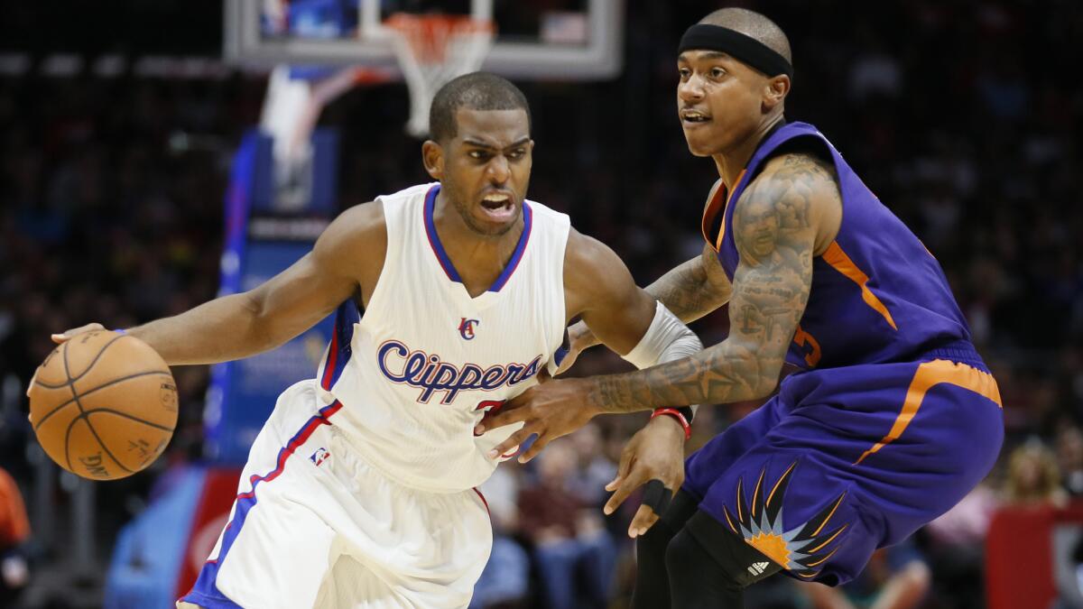 Clippers point guard Chris Paul, left, tries to drive past Phoenix Suns guard Isaiah Thomas during the second half of the Clippers' 120-107 victory at Staples Center on Saturday.
