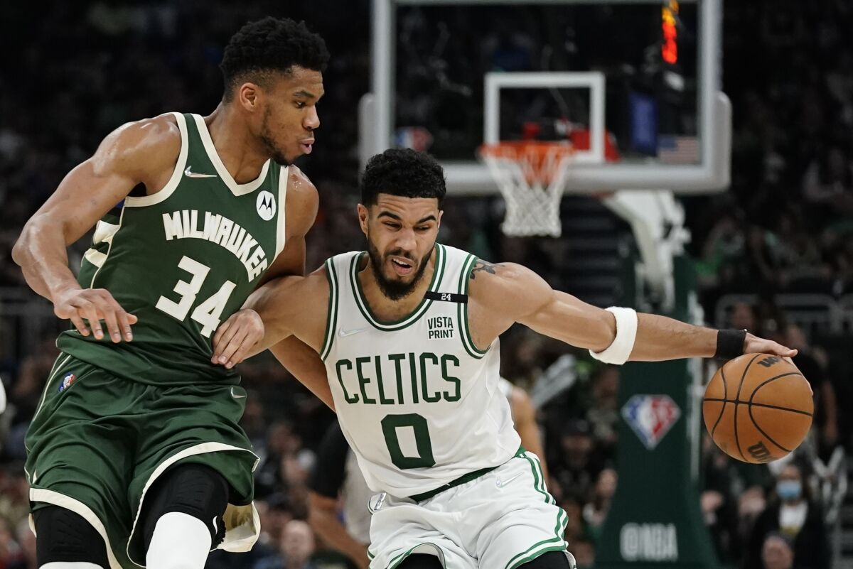 Boston Celtics' Jayson Tatum tries to get past Milwaukee Bucks' Giannis Antetokounmpo during the second half of Game 6 of an NBA basketball Eastern Conference semifinals playoff series Friday, May 13, 2022, in Milwaukee. The Celtics won 108-95 to tie the series at 3-3. (AP Photo/Morry Gash)