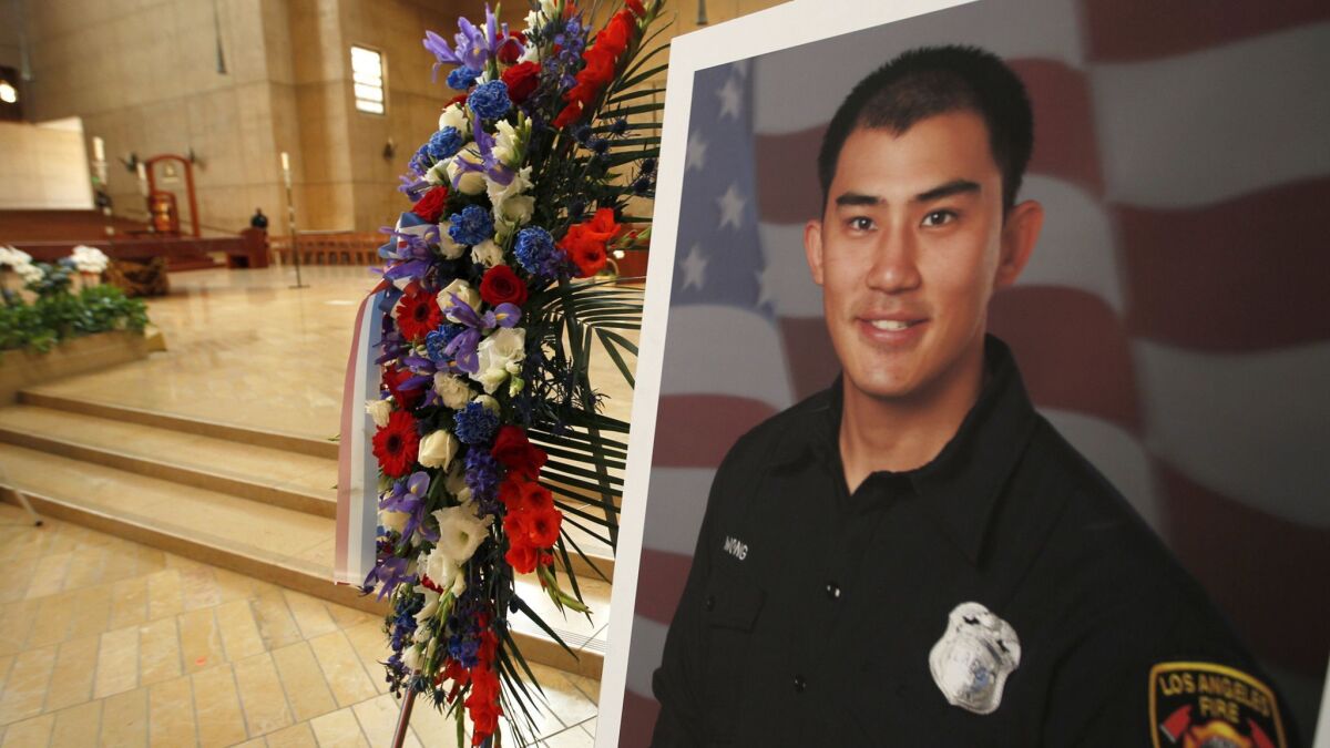 A picture of fallen Los Angeles firefighter Kelly Wong stands in front of the Cathedral of Our Lady of the Angels prior to his funeral on June 16, 2017.
