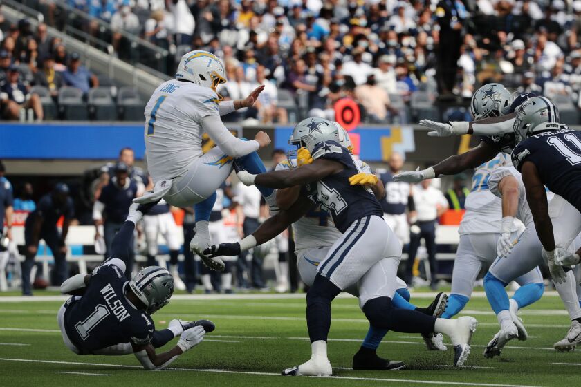 Dallas Cowboys defensive end Azur Kamara is charged with roughing the kicker on Los Angeles Chargers punter Ty Long