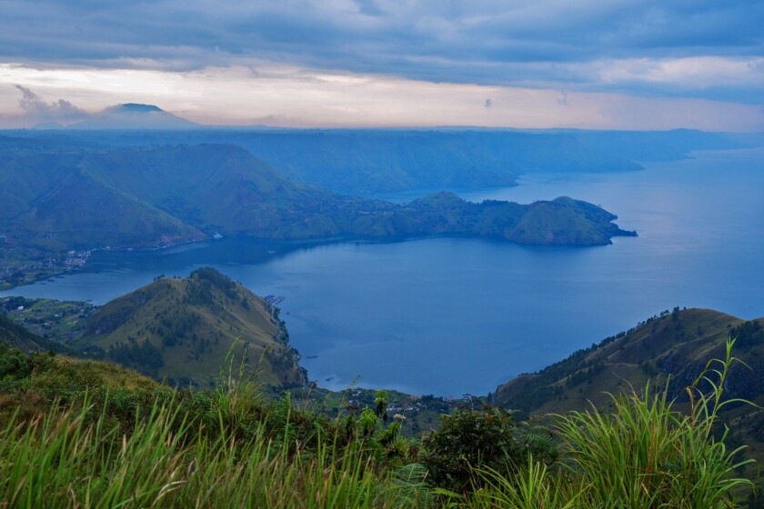 Lake Toba in Indonesia was formed 75,000 years ago after a violent volcanic eruption. It's now home to a large Christian minority, which is resisting plans to transform the region into a major Muslim tourist destination.